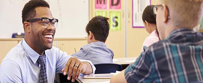 Smiling black male teacher wearing glasses